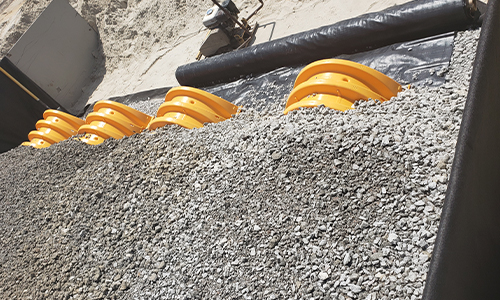 rocks covering drainage pipes